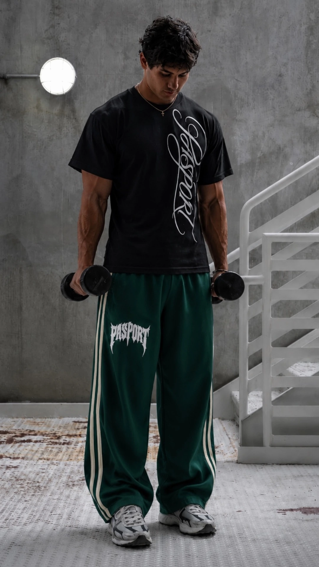 Black graphic tee with green wide-leg track pants