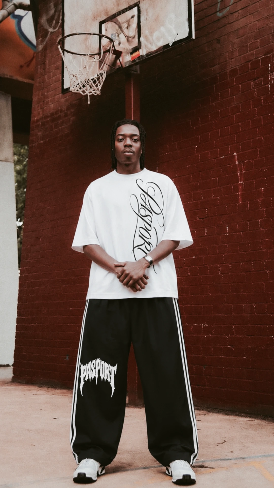 White graphic tee with black wide-leg track pants